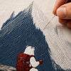 Close-up of SunnySass Sunlit Peaks dense mountain embroidery on the back of a white T-shirt