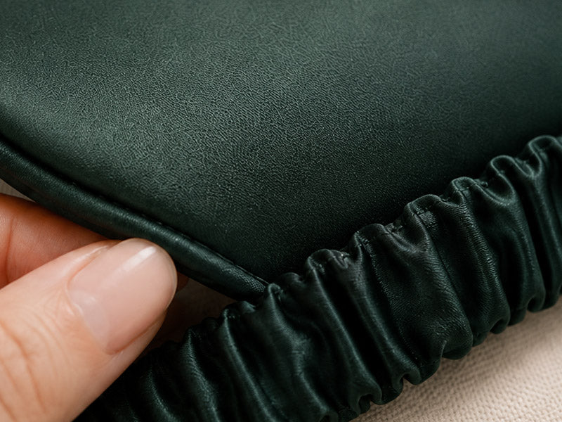 Forest green silk sleep mask beside pure silk-fiber filling